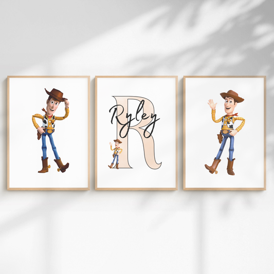 Three framed wall art prints displayed side by side on a white wall with soft shadow overlays. The center print features a large beige letter R with the name Ryley in black script, and the side prints show Woody the cowboy from Toy Story in two different poses.