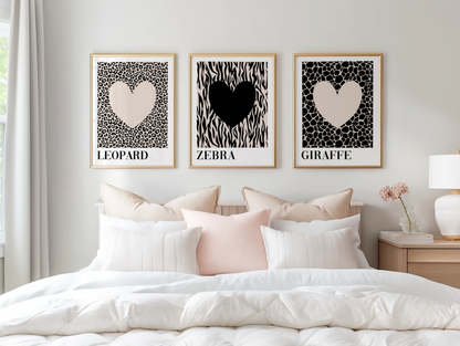 Minimalist bedroom decorated with monochrome animal print wall art showcasing leopard, zebra and giraffe heart prints for a calm, modern interior.