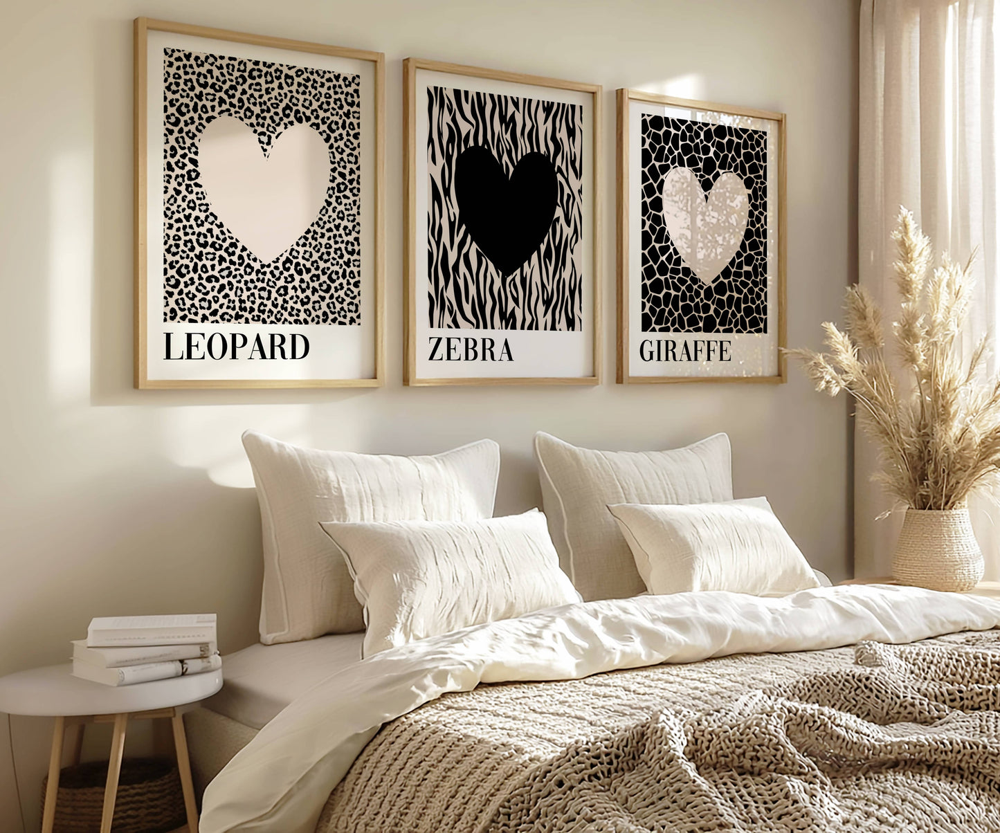 Modern bedroom styled with neutral safari wall art featuring leopard, zebra and giraffe heart prints above a soft cream bed in a Scandinavian-inspired interior.