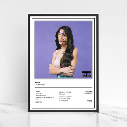 Framed Olivia Rodrigo SOUR album cover prints displayed in a modern neutral home interior.