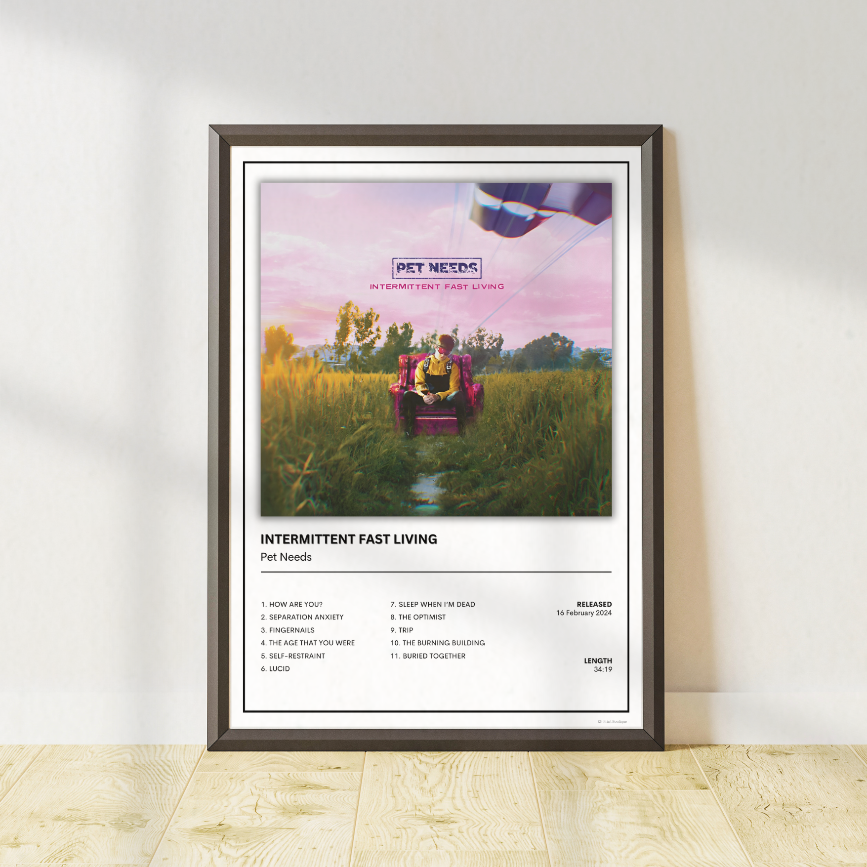 Pet Needs Intermittent Fast Living album tracklist print in a modern black frame for indie rock home decor.