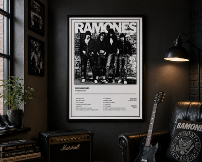 A framed black and white Ramones concert poster hangs on a dark wall in a styled room with a guitar, Marshall amp, plant, and lamp.