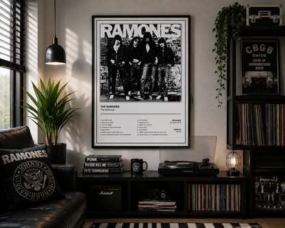 A framed black-and-white Ramones poster hangs on a wall in a styled room with a record player, shelves, plants, and a leather chair. The poster features the band's logo and album artwork.