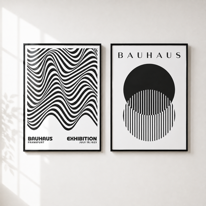 Two framed Bauhaus art prints hanging side-by-side on a white wall, with soft window shadow patterns visible on the left side of the wall.