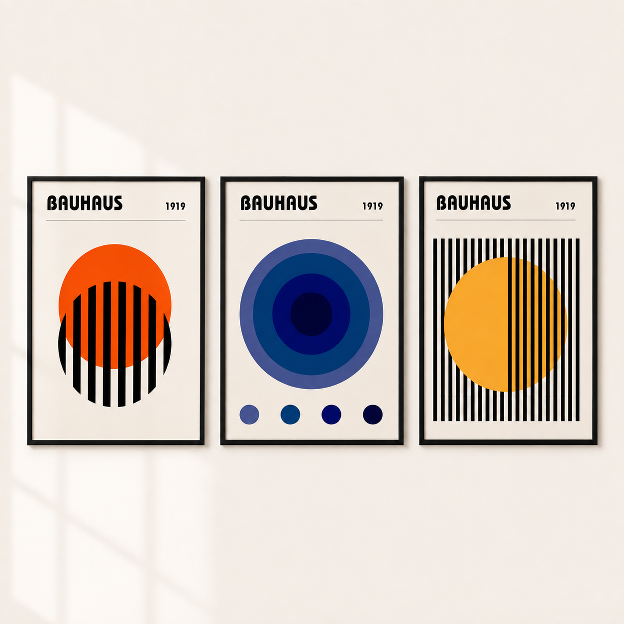 Three framed Bauhaus-style abstract art prints displayed side by side on a light beige wall. Each print features bold geometric shapes, including circles, stripes, and concentric rings in orange, blue, yellow, black, and white, with the text 'BAUHAUS 1919' at the top.