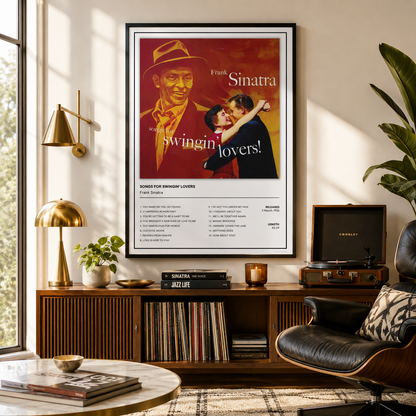 A framed Sinatra poster hangs on a wall above a wooden console in a styled living room. The poster features a red and cream cover with the text 'Frank Sinatra' and 'swingin' lovers!' plus a song list at the bottom.