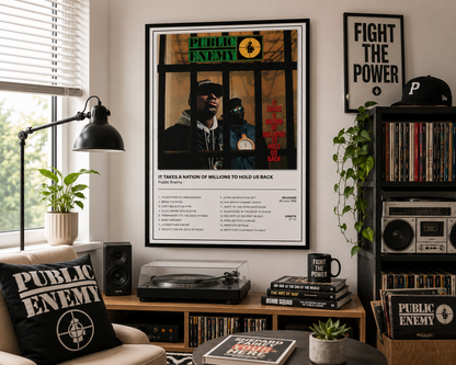 A framed Public Enemy wall art print hangs in a styled room with a turntable, speakers, plants, and vinyl records. The print features the band's album cover art and track listing, with the text 'IT TAKES A NATION OF MILLIONS TO HOLD US BACK'.