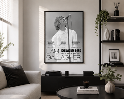 Framed Liam Gallagher Knebworth Park 2022 setlist wall art displayed in a stylish contemporary living room with modern black furniture.