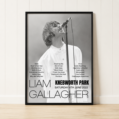 Liam Gallagher Knebworth Park 2022 concert poster print in a black frame leaning against a minimalist cream panelled wall.