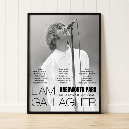 Liam Gallagher Knebworth Park 2022 concert poster print in a black frame leaning against a minimalist cream panelled wall.