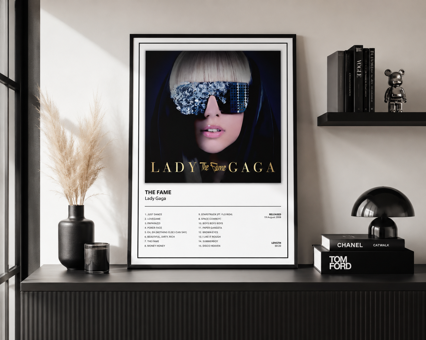 Framed Lady Gaga The Fame music poster with album artwork and tracklist displayed as contemporary pop music wall art for home or studio.