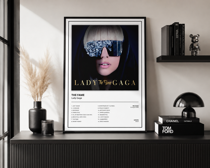 Framed Lady Gaga The Fame music poster with album artwork and tracklist displayed as contemporary pop music wall art for home or studio.
