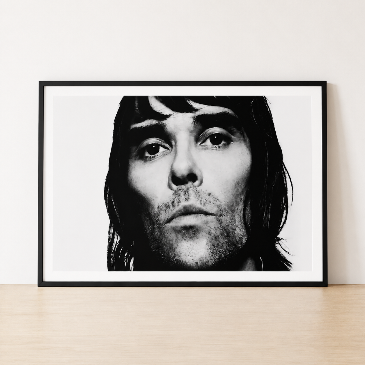 Black and white Ian Brown portrait print in a minimalist black frame with a wide white mount.