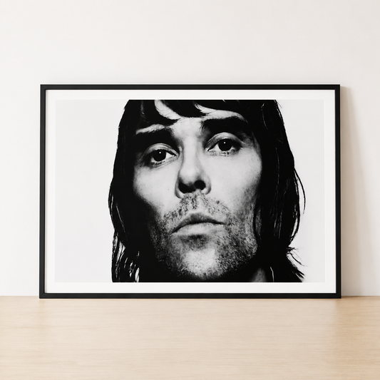 Black and white Ian Brown portrait print in a minimalist black frame with a wide white mount.