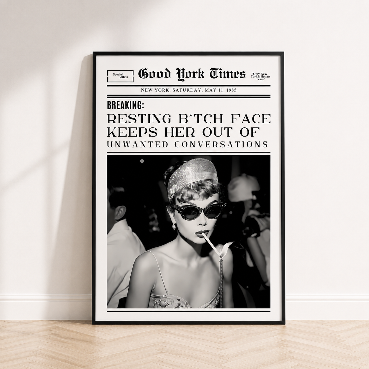Resting B*tch Face newspaper wall art inspired by Audrey Hepburn in black frame displayed in a luxury modern bedroom.