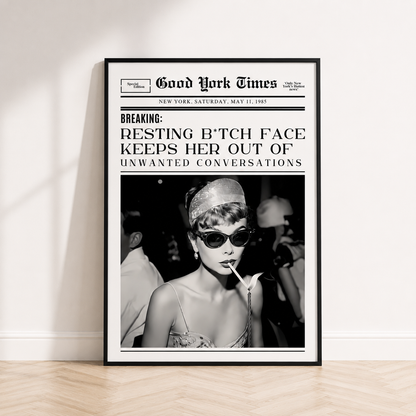 Resting B*tch Face newspaper wall art inspired by Audrey Hepburn in black frame displayed in a luxury modern bedroom.