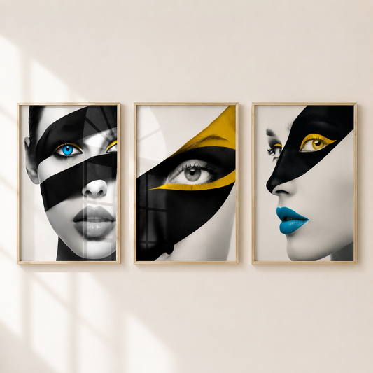 Three framed vertical wall art prints featuring stylized close-up portraits of a woman's face with black mask-like bands and bold eye makeup, hung side by side on a light beige wall.