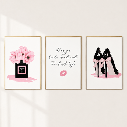 Three framed wall art prints hanging on a light beige wall. The left print shows pink flowers in a black perfume bottle with the text 'Paris'.