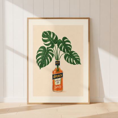 Aperol Monstera Botanical Print featuring tropical green monstera leaves displayed in an iconic Aperol bottle, inspired by Mediterranean interiors and Italian aperitivo culture.