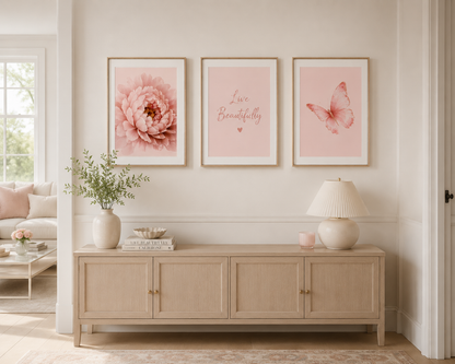 Blush pink peony flower, butterfly and Live Beautifully quote wall art set above a wooden sideboard in a neutral home interior.