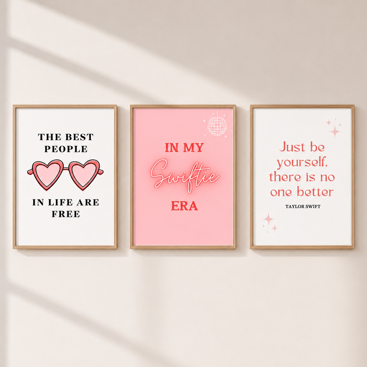 Pink Swiftie-inspired wall art set with three preppy coquette bedroom prints in light oak frames.