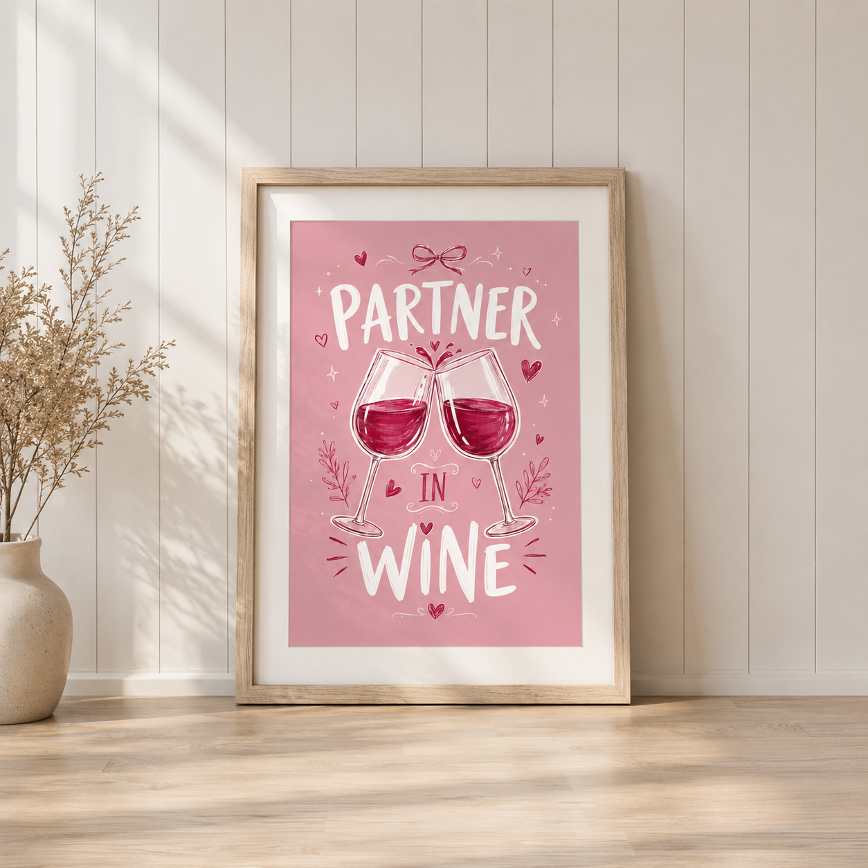 Partner In Wine pink wine lover wall art print in light oak frame displayed in stylish home interior.