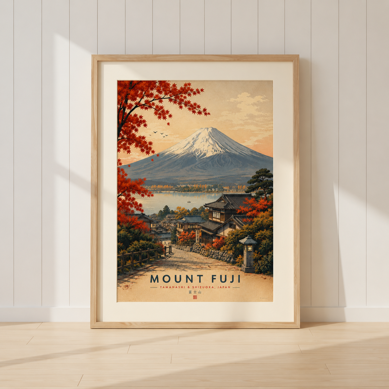 Mount Fuji travel poster featuring traditional Japanese village and autumn maple leaves.