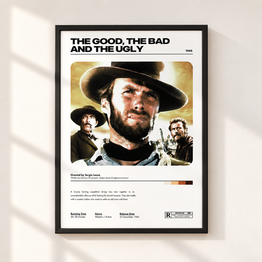 A framed movie poster for 'The Good, The Bad and The Ugly' hangs on a light beige wall. The poster features a black frame, a white background, and a stylized retro graphic of Clint Eastwood's character with a cowboy hat and beard, along with film credits and release details.