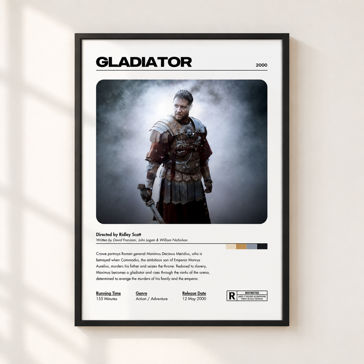 A framed movie poster for the film 'Gladiator' is displayed on a light beige wall with soft diagonal shadows. The poster features a black frame, a white background, and a central image of the character Maximus in armor.