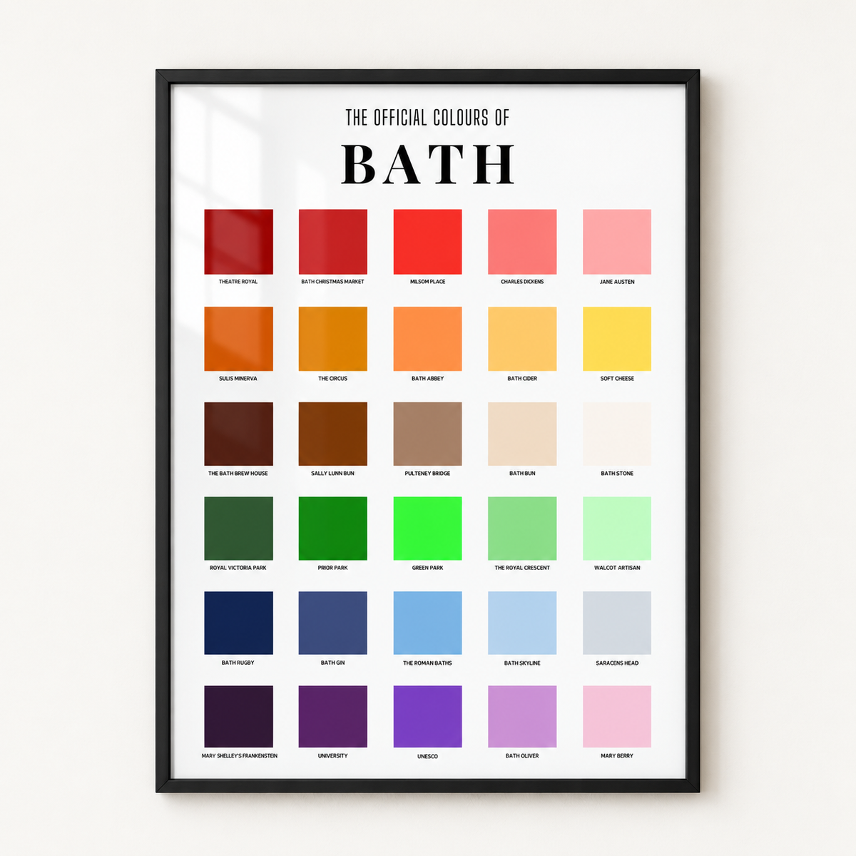 A framed poster titled 'THE OFFICIAL COLOURS OF BATH' showing a grid of color swatches in various shades, photographed hanging on a light wall.