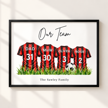 A framed personalized wall art print showing four red-and-black striped soccer jerseys with the names Dad, Mum, Oliver, and Rosie, plus the text 'Our Team' and 'The Sawley Family'. The framed print is displayed against a light wall with soft window shadows.