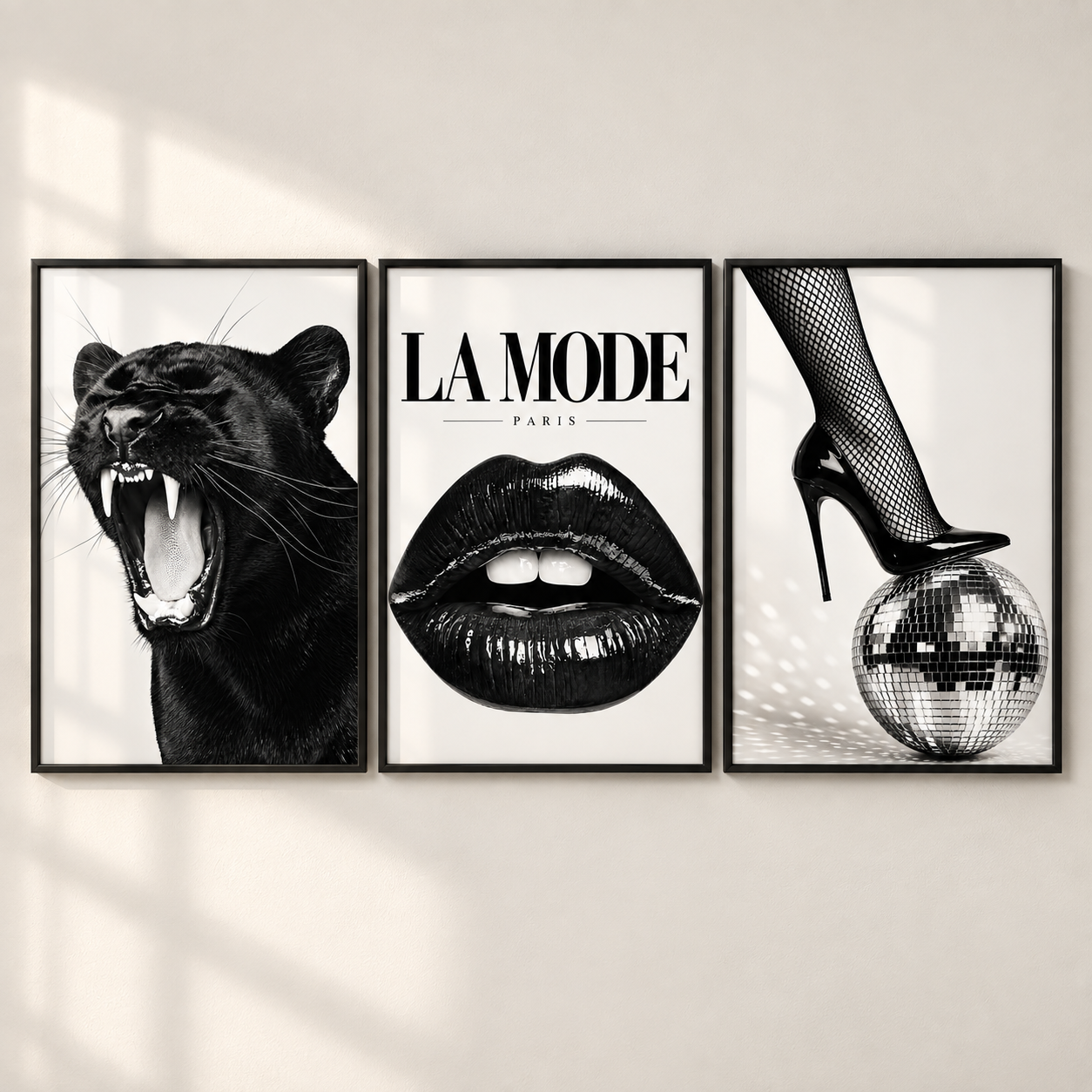 Three framed black and white art prints displayed side-by-side on a light beige wall. The left print shows a roaring black panther, the middle print features the text 'LA MODE PARIS' above glossy lips, and the right print shows a high-heeled foot in fishnet stockings stepping on a disco ball.
