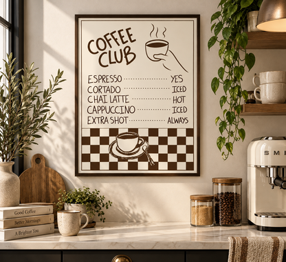 A framed coffee-themed wall print with a checklist reading 'COFFEE CLUB' hangs on a kitchen wall above a counter. The print has brown text and graphics on a cream background, including a coffee cup illustration and a brown-and-white checkerboard section at the bottom.