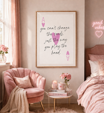 Pink-themed bedroom with motivational poster, pink chair, and 'good vibes' neon sign.
