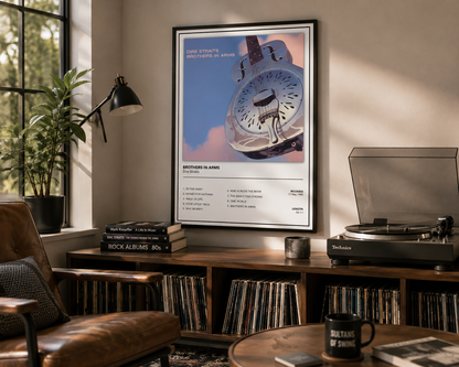 A framed music poster for 'Dire Straights' album 'Brothers in Arms' hangs on a wall in a cozy, sunlit room with a wooden record shelf, vinyl records, a brown leather chair, and a turntable.