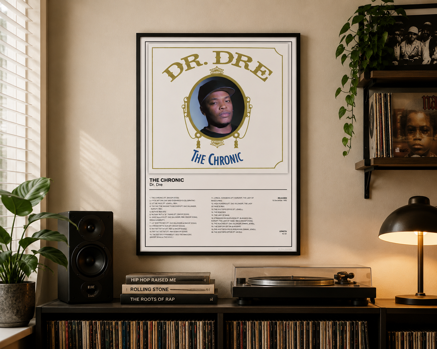 A framed music poster of Dr. Dre's 'The Chronic' hanging on a beige wall in a styled room with a speaker, turntable, books, and a lamp.