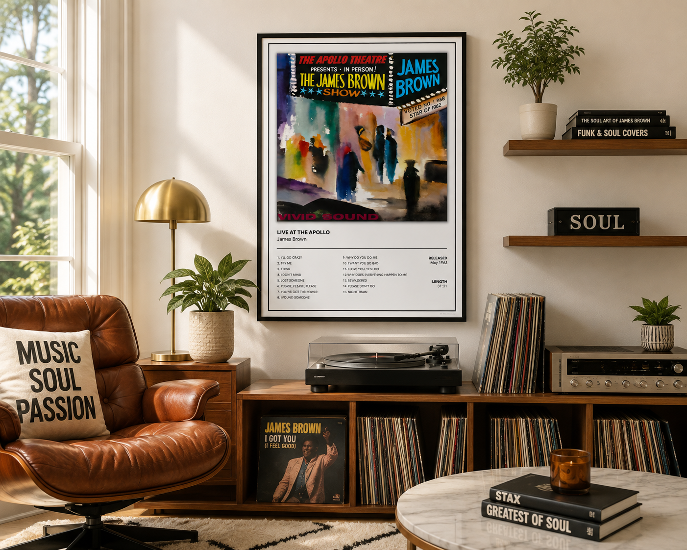 A framed James Brown concert poster hangs on a beige wall in a styled living room with a brown leather chair, record shelves, plants, and a turntable.