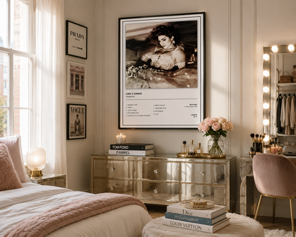 A framed fashion poster featuring a black-and-white portrait of Madonna with the text 'LIKE A VIRGIN' and a list of tracks, displayed on a wall in a styled bedroom setting.