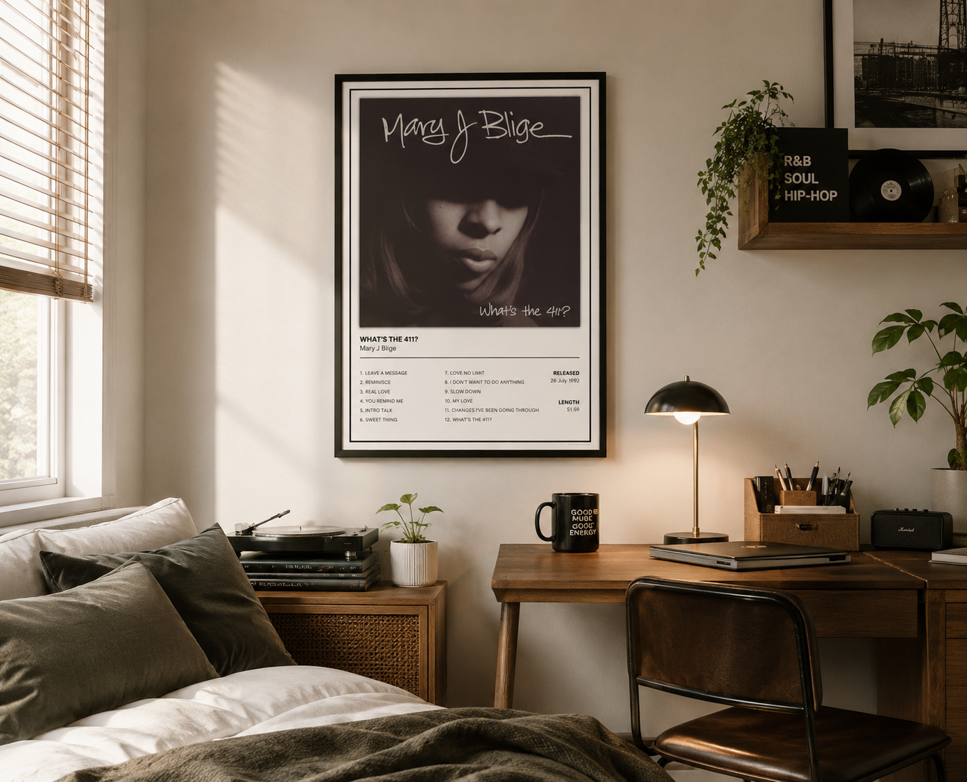 A framed Mary J. Blige 'What's The 411' music poster hanging on a beige wall in a styled bedroom.
