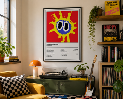 A framed art print of 'Primal Scream Screamadelica ' hanging on a wall in a cozy, styled room with a record player, guitar, plants, and shelves.
