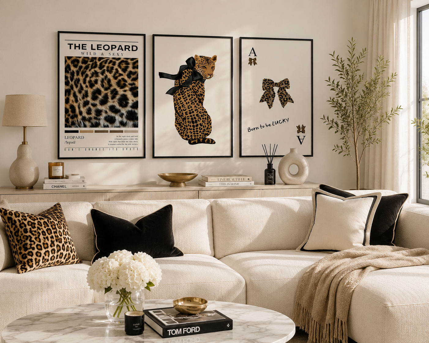 Luxury leopard gallery wall featuring modern leopard artwork, elegant bow print and contemporary fashion posters displayed above a stylish cream sofa in a bright living room.