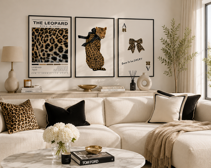 Luxury leopard gallery wall featuring modern leopard artwork, elegant bow print and contemporary fashion posters displayed above a stylish cream sofa in a bright living room.
