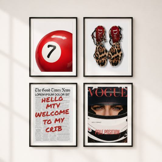 Four framed wall art prints arranged in a 2x2 grid on a white wall, with soft window-shadow lighting. The prints feature pop-culture and fashion-themed designs: a red billiard ball with the number 7, a pair of leopard-print high heels with red 'D' logos, a newspaper-style poster with red text reading 'HELLO MTV WELCOME TO MY CRIB', and a Vogue racing helmet cover with a driver's face.