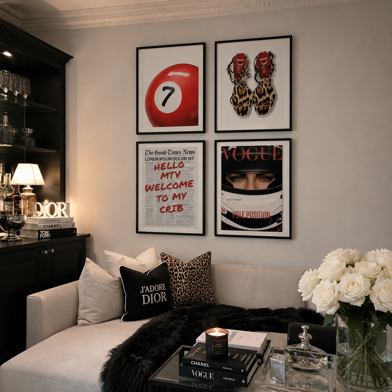 A styled interior scene showing four framed wall art prints above a sofa. The prints feature a red billiard ball with the number 7, leopard-print shoes, a fashion quote poster, and a Vogue magazine cover with a racing helmet.