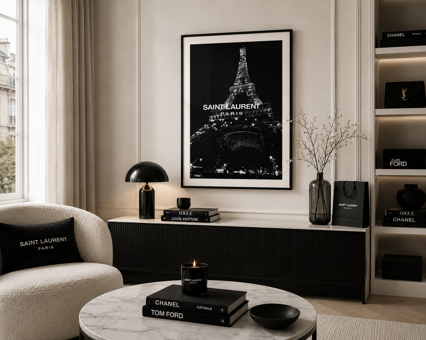 A framed black and white poster of the Eiffel Tower with 'SAINT LAURENT PARIS' text, displayed on a wall in a modern, elegant living room setting with a cream armchair, marble coffee table, and shelves.
