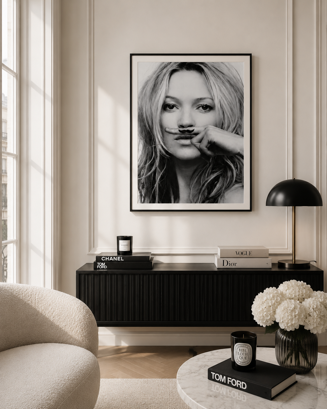 A black and white framed art print of a woman with a mustache hanging on a beige wall in a modern living room setting above a black sideboard.