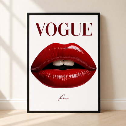 A framed Vogue art print leaning against a beige wall on a light wood floor. The print features a large pair of glossy red lips on a white background with the word 'VOGUE' in dark red serif letters at the top and a small signature reading 'Paris' below.