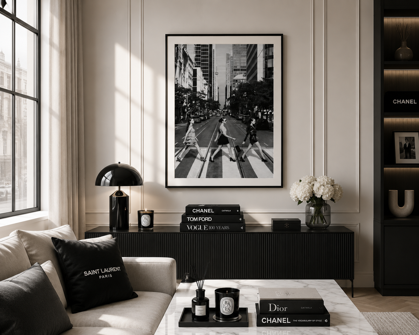 A black and white framed art print of the Abbey Road crosswalk scene, styled in a modern living room setting above a dark console table.