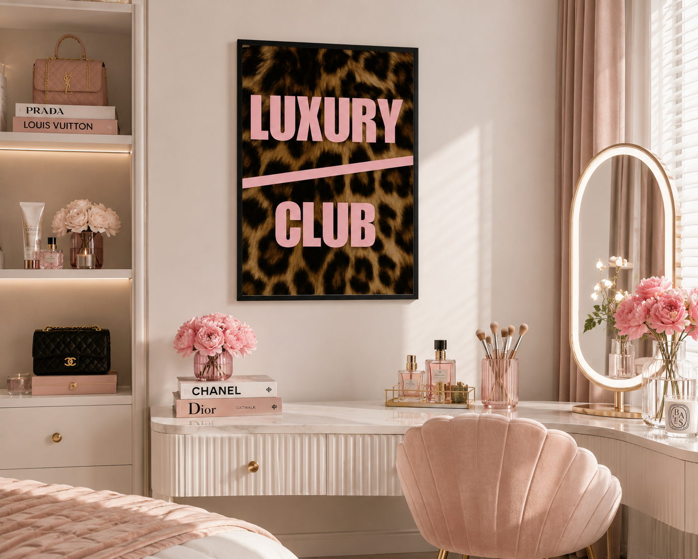A framed wall art print with a leopard print background and the words 'LUXURY CLUB' in pink lettering, displayed in a styled bedroom or vanity area with pink furniture, flowers, and cosmetics.