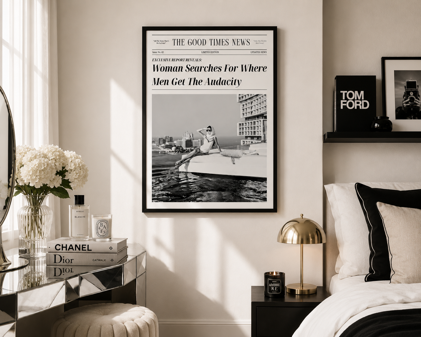 A framed black-and-white newspaper-style wall print hangs above a bed in a styled bedroom. The print features a large headline and a photo of a woman in a boat.